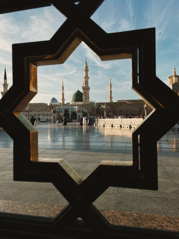 Capture of Al-Masjid an-Nabawi through beautifully patterned window frame in Medina, Saudi Arabia.